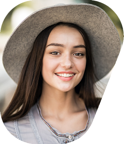 Smiling young woman wearing a gray hat in a soft outdoor portrait